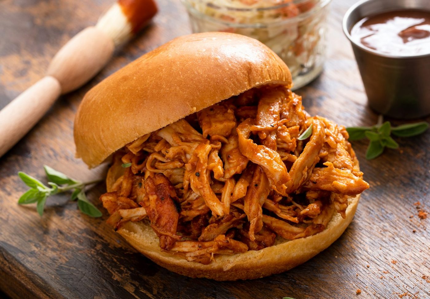 BBQ chicken sandwich on a brioche bun with coleslaw