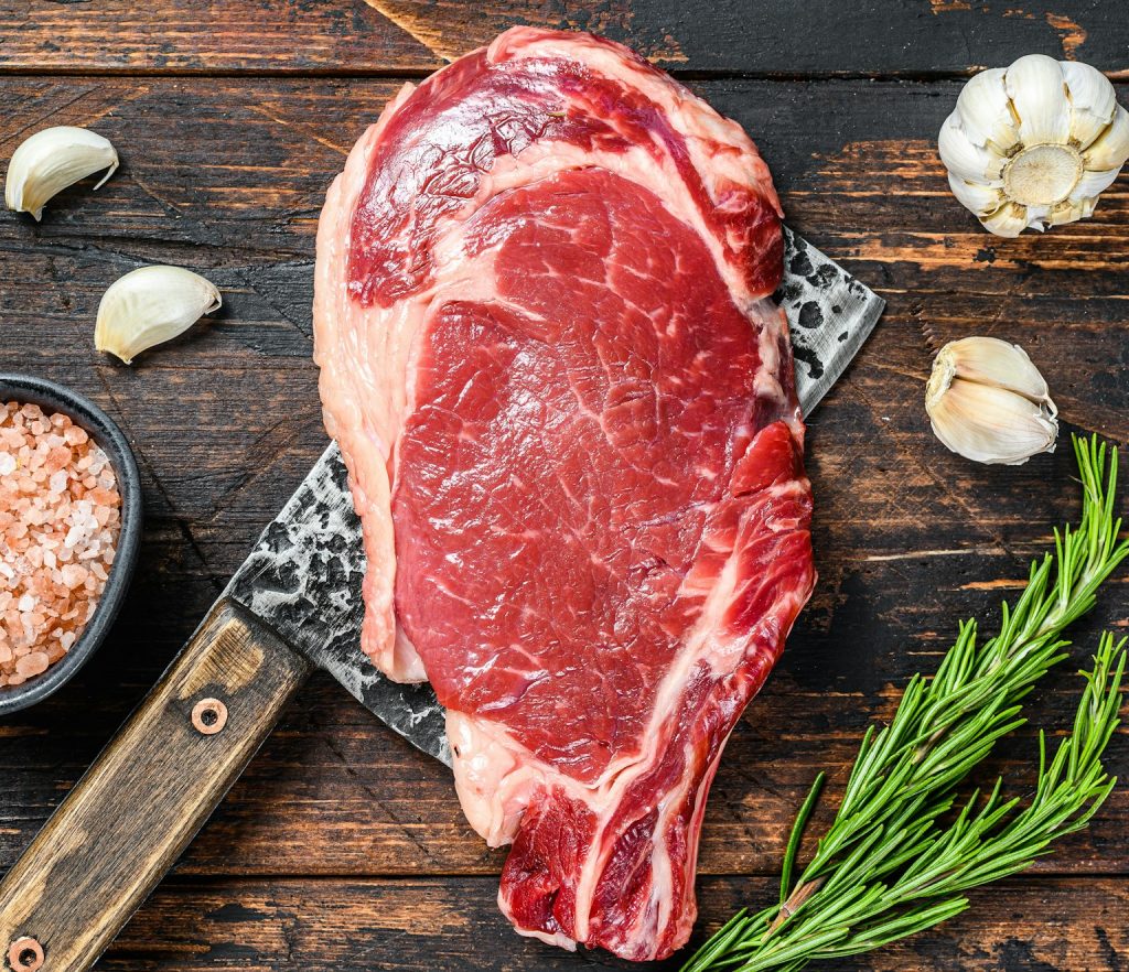 Rib eye steak on a meat cleaver. Raw Marble beef black Angus, ribeye